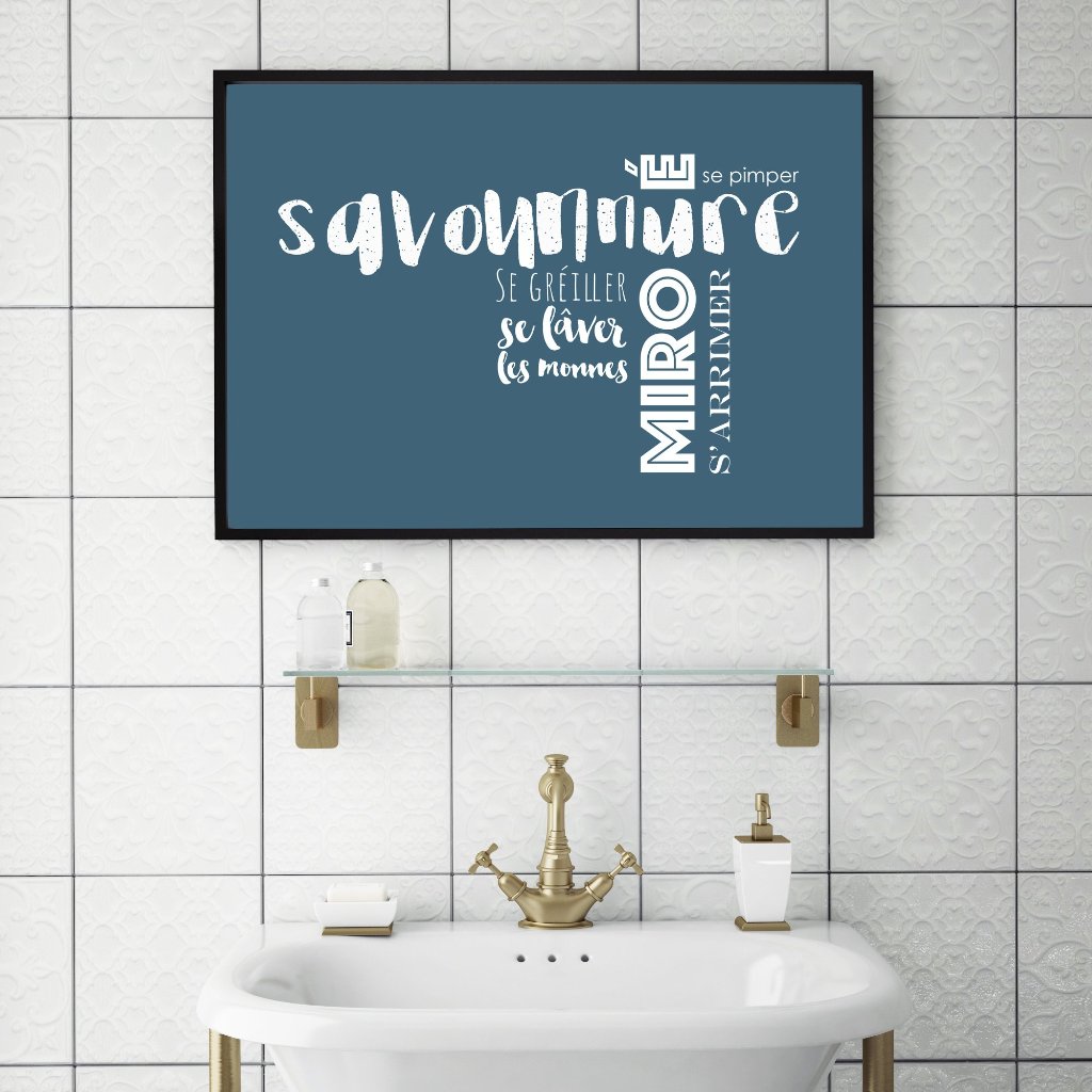 An Acadian french print framed and above a sink.