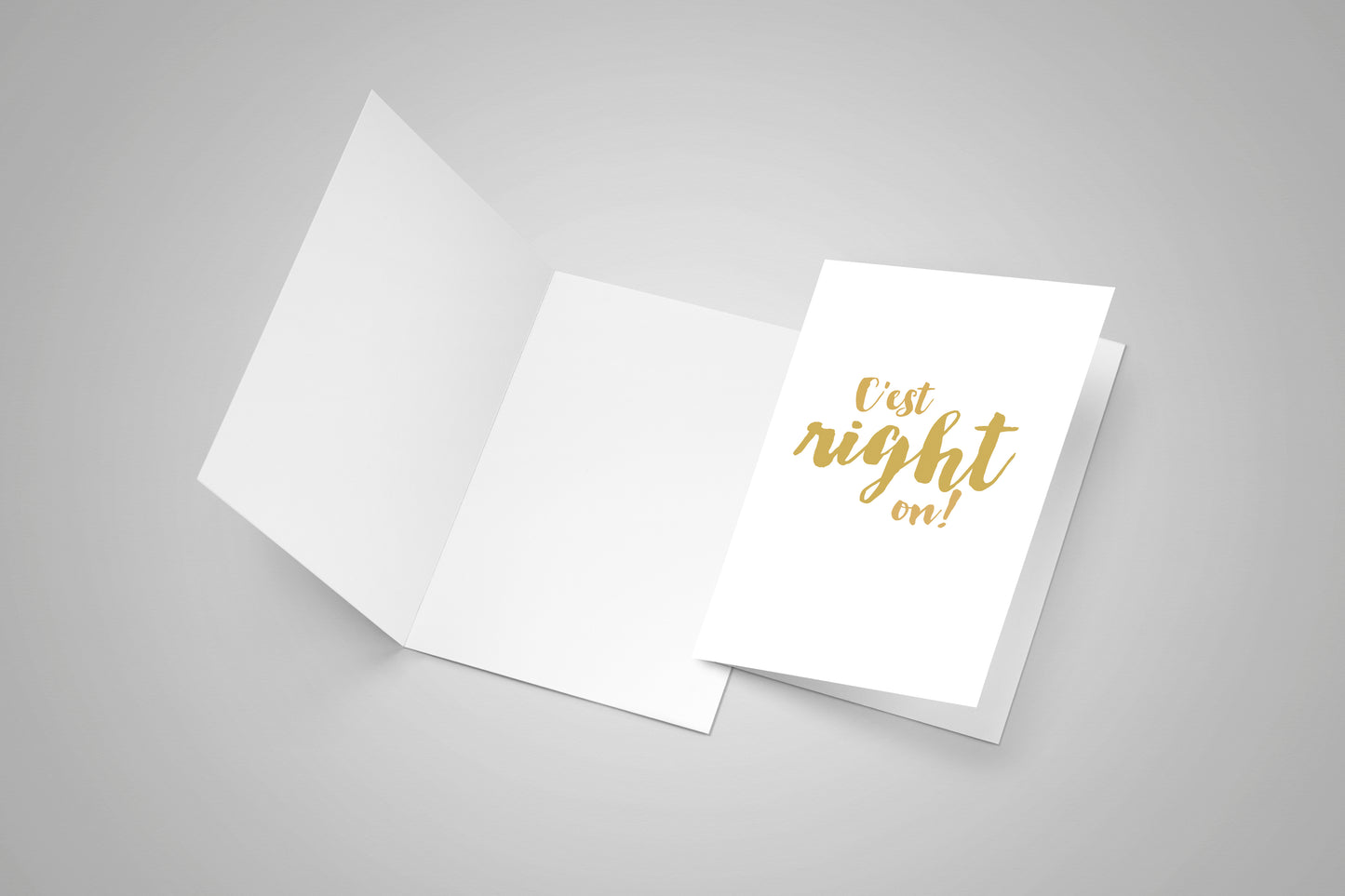 One blank open greeting card and a second closed greeting card with a french Acadian saying on the front.