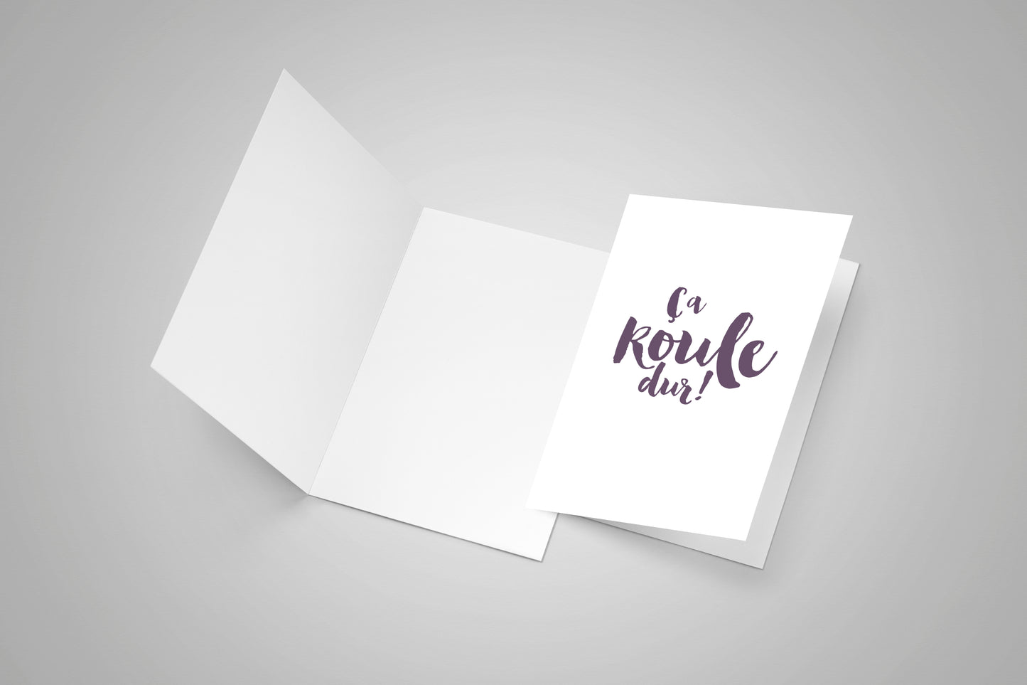 Blank open greeting card and a second closed greeting card with an Acadian saying on the front.