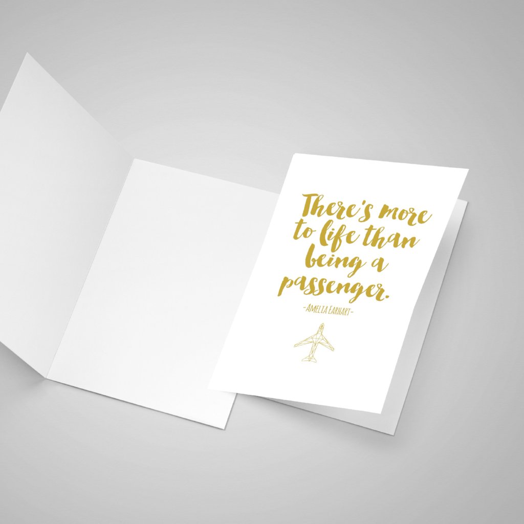 One blank open greeting card and one closed greeting card with Amelia Earhart quote in yellow font and her quote saying "There is more to life than being a passenger."