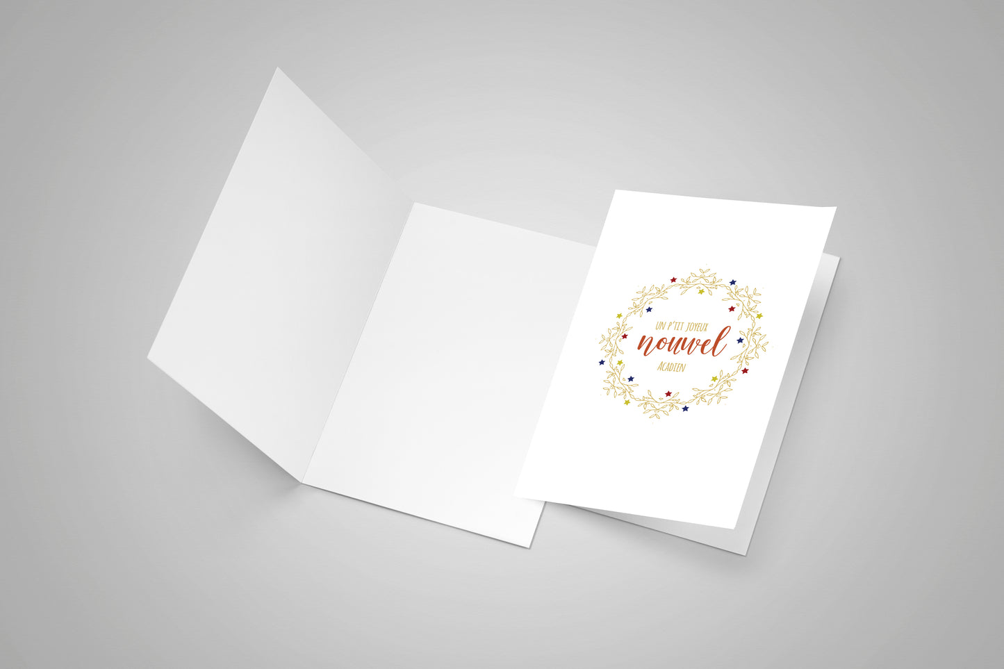 A open blank greeting card with a closed greeting card with an Acadian Merry Christmas on the front.