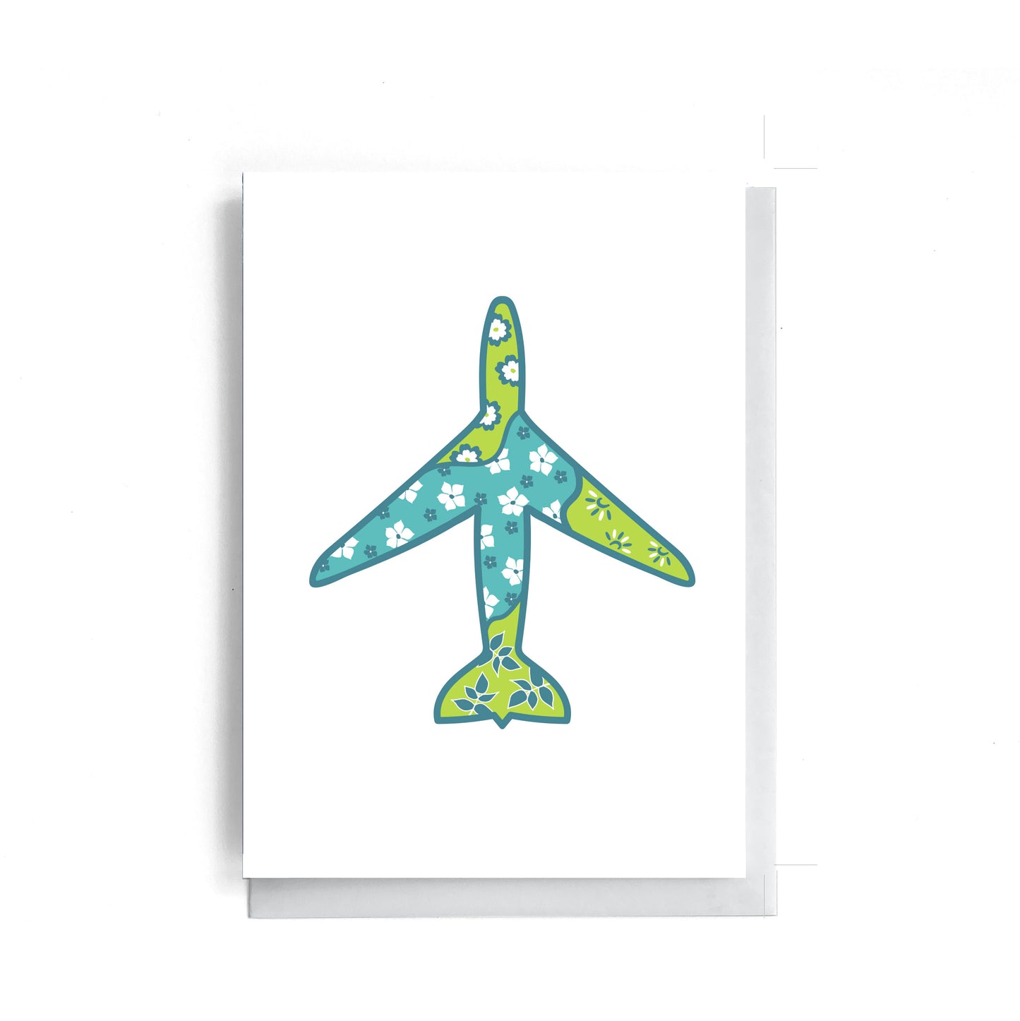 Greeting card on a white surface. On the greeting card there is a floral patterned airplane.