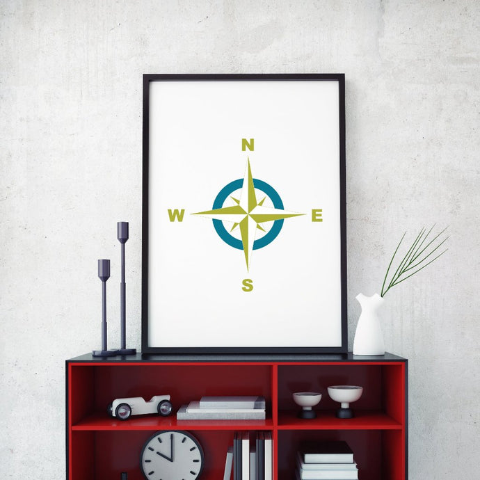 A compass rose art design framed on a table.